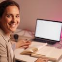 Freelance writer smiling beside a notebook and a laptop in a quiet studio